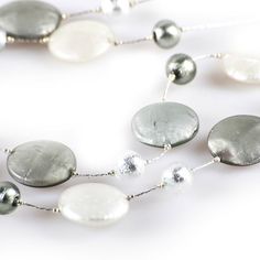 "FRANCY SATIN silver and grey glass necklace Murano glass long necklace, featuring handmade grey and silver beads. This elegant creation is the perfect accessory to make any outfit unique and special! Length: 66 cm / 26 \" Weight: 110 gr / 0,24 lb Trademark Of Origin Code: 065 Free shipping worldwide Handmade by one of our famous Murano glassmakers Item condition NEW WITH TAGS Trademark of Origin guaranteed Shipped from Venice with insurance Feel free to contact us for any further information. W Silver Necklace With Round Beads For Party, Silver Necklaces With Round Beads For Party, Silver Party Necklaces With Polished Beads, Silver Necklaces With Polished Beads For Party, Long Silver Pearl Necklace For Party, Modern Silver Beaded Necklace, Silver Beaded Long Necklace For Party, Modern Silver Glass Necklaces, Elegant Silver Jewelry With Glass Material