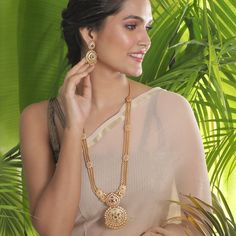 The gold beaded chain necklace that sizzles the room, this long necklace is royal charm. Excellent to pair with a kanjivaram or handloom saree. Specification: Weight - 100 gm (necklace); 19 gm (earring); Length - 36 cm (necklace); 8 cm (earring), 100% Satisfaction Guarantee:  1 Year Warranty, Long Lasting Plating, High-Quality Stones. Gifting:  This Indian long necklace set comes in a beautiful Tarinika gift box, making it an ideal gift for birthday, wedding anniversary or wedding gift.  Occasion: Perfect choice for any Indian occasion.  Care: It is advisable that you keep Tarinika products away from direct heat, humidity, and moisture. It is best to preserve your Tarinika jewelry in the box. Return/Exchange Policy:  We provide 14 days return/exchange policy. Contact us for any questions. Indian Long Necklace, Indian Jewelry Set, Long Necklace Set, Gold Necklace Indian, Necklace Set Indian, Indian Necklace, Indian Jewelry Sets, Diamond Solitaire Necklace, Gold Necklace Designs