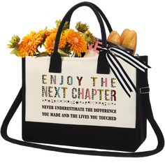 a black and white bag with flowers on the side that says enjoy the next charter