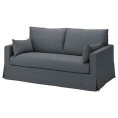 a gray couch with two pillows on it's back and one arm facing the camera