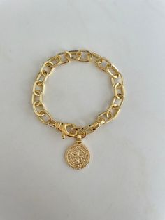 The Coin Gold Bracelet. Chunky link chain with a large spring closure allows for an adjustable length. Same design on each side of the coin. Bracelet measures approximately 7.5" The replica coin measures 3/4". Pendant and chain are gold filled, tarnish resistant Gold-plated Charm Bracelet With Gold Chain, Gold Plated Round Charm Bracelet With Gold Chain, Gold Plated Charm Bracelet With Round Gold Chain, Gold-tone Tarnish Resistant Chain Bracelet, Round Metal Charm Bracelet With Gold Chain, Gold Chain Metal Charm Bracelet, Adjustable Round Gold Chain Bracelet, Gold Brass Round Chain Bracelet, Gold-tone Tarnish Resistant Charm Bracelet