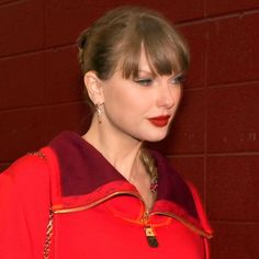 a woman in a red dress with braids on her hair