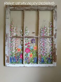 an old window with flowers painted on the side and words that read, right up my alley designs