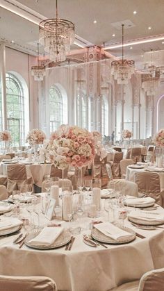 the tables are set with white linens and pink flowers