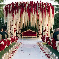 the aisle is decorated with red and white flowers