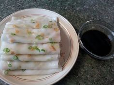 a plate that has some food on it next to a cup of black liquid and a spoon