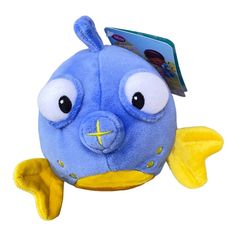 a blue fish stuffed animal with yellow feet and large eyes, holding a book in its mouth