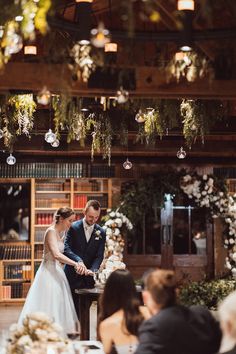 the bride and groom are getting ready to cut their wedding cake at the reception table