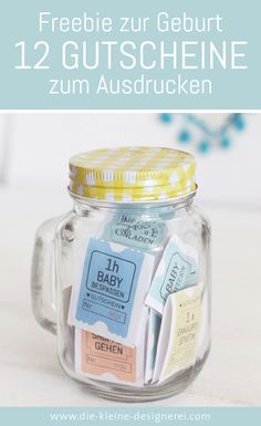 a glass jar with some tags in it and the words freebie zur geburt