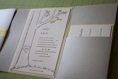 an open wedding card with a tree on it