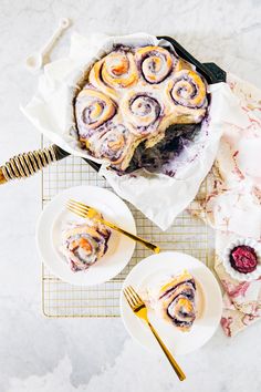 a table topped with two plates of food and a cake on top of a cooling rack