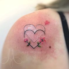 a woman's shoulder with a heart and flowers on it