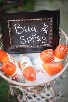 there is a sign that says bug spray on the side of a basket with baby bottles in it