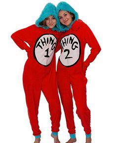 two women in red onesuits with the thing on their chest and blue hair standing next to each other