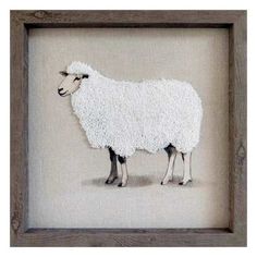 a sheep made out of yarn in a wooden frame on the floor with white background