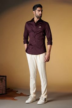 Plum classic shirt with placement embroidered crest in front and front button down detailing.
Component: 1
Type Of Work: Plain
Neckline: Collar
Sleeve Type: Full sleeves
Fabric: Giza Cotton
Color: Purple
Other Details: 
Front button detailing
Note: Pant worn by the model is not for sale
Occasion: Party - Aza Fashions Embroidery Shirt Men, Purple Plain, Embroidery Shirts, Purple Shirt, Shirt Embroidery, Cotton Embroidery, Colour Combination, Giza, Full Sleeves