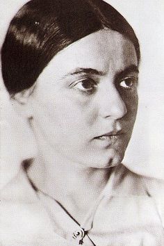 an old black and white photo of a woman's face with her eyes wide open