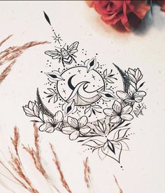 a drawing of the sun and moon with flowers on it's side next to some dry grass