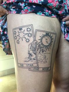 a woman with a tattoo on her thigh that reads, the star at the moon