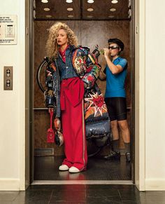 a man and woman standing in an elevator