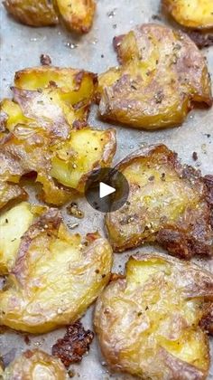 cooked potatoes on a baking sheet with seasoning in the foreground and an image of fried potatoes being prepared