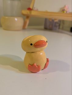 a toy duck sitting on top of a table