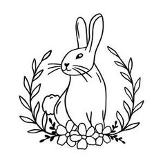 a rabbit sitting in the middle of some flowers and leaves with its head turned to the side