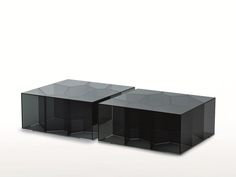 two black glass tables sitting next to each other