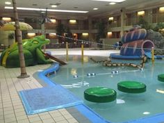 an indoor swimming pool with slides and toys