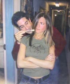 a man and woman brushing their teeth in front of a mirror with the reflection of them