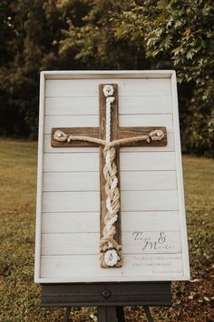 a wooden cross on top of a sign