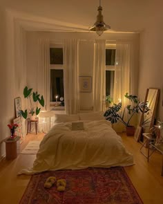 a bedroom with a large bed and lots of plants