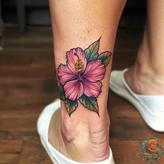 a woman's foot with a pink flower tattoo on her left side calfocks