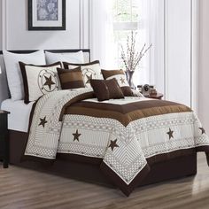 a bed with brown and white comforters in a room