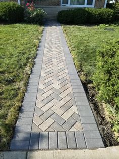 a brick walkway in front of a house