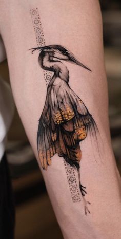 a tattoo with a bird on it's arm