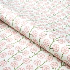 pink flowers on white fabric with green stems