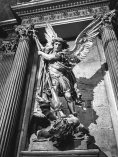 an angel statue on the side of a building