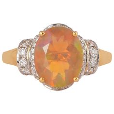 an orange fire opal and diamond ring