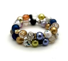 This gorgeous glam bracelet set is a cohesive pairing that features bold navy, metallic shades, lime, rust and more.  This will become quite possibly a Go To set to be worn together or split up to join others.  The thread between them is likely the speckled beads.   Definitely a wow look.  Check out the varied textures and beads--a cool and eclectic class act.  Get your Glam On!!  Classic boutique, forever in style.  Timeless.     ►►These currently fits a 6 inch wrist.  If you need an adjustment Elegant Multicolor Stackable Stretch Bracelet, Vintage Multicolor Spacer Beads, Vintage Multicolor Hand-strung Beaded Bracelets, Vintage Multi-strand Beads, Retro Bracelet, Multi-strand Polished Czech Glass Beads, Polished Czech Glass Multi-strand Beads, Navy Gold, Bracelet Set