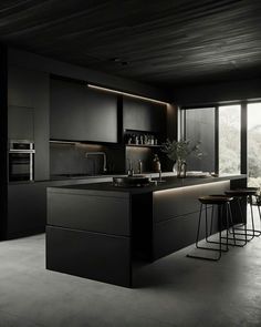 a kitchen with black cabinets and stools in front of an open window that looks out onto the outdoors