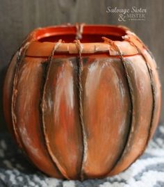 a close up of a clay pot on a table with rope wrapped around the bottom