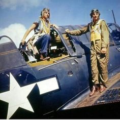 two people sitting in the cockpit of an old fighter plane with a star on it