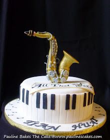 a birthday cake with a musical instrument on top