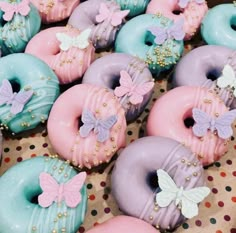 there are many doughnuts that have been decorated with different colors and designs on them