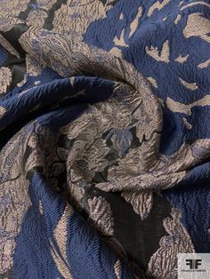 the fabric is blue and grey with flowers on it