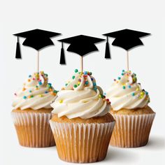 three cupcakes with graduation caps on top