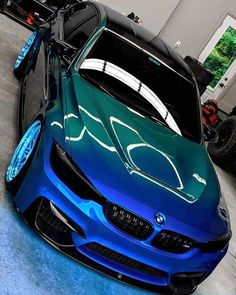 a blue and green car parked in a garage