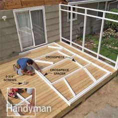 a man working on a deck in front of a house