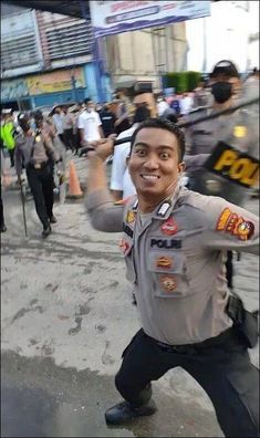 a man in uniform is dancing on the street